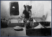 Woman grinding corn. Courtesy Denver Public Library, Western History Collection, Charles A. Nast, X-30779.
