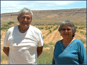 Hopi man and woman with cornfield in background. Photo by Karen R. Adams.